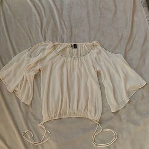 Cream sheer top with bell sleeves and rhinestones